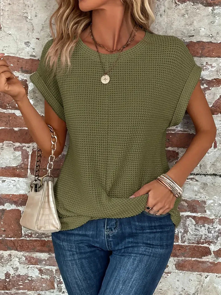 Casual women's crew neck short sleeve top in waffle knit, enhanced with a trendy front twist.