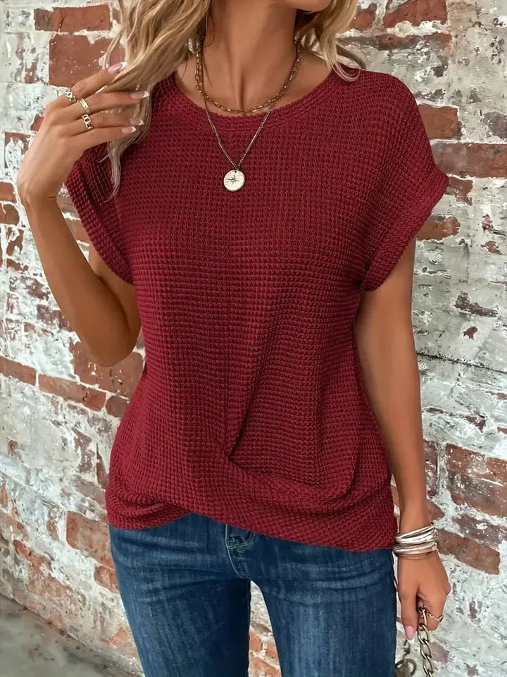 Waffle knit short sleeve top for women with a flattering front twist. Comfortable and casual everyday sweater.