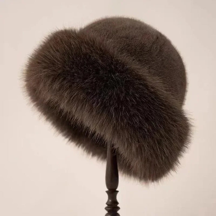 Warm women's faux fur winter hat with a wide cuffed brim, a fluffy and stylish fashion accessory.
