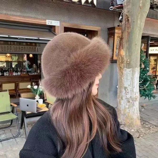 Stylish women's warm faux fur winter hat with a wide cuffed brim for cold weather fashion.