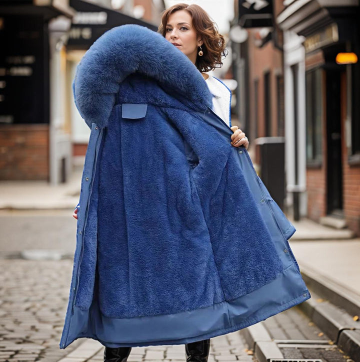 Women's warm waterproof winter coat, modern fit, sleek design, with hood and adjustable cuffs for wet conditions.