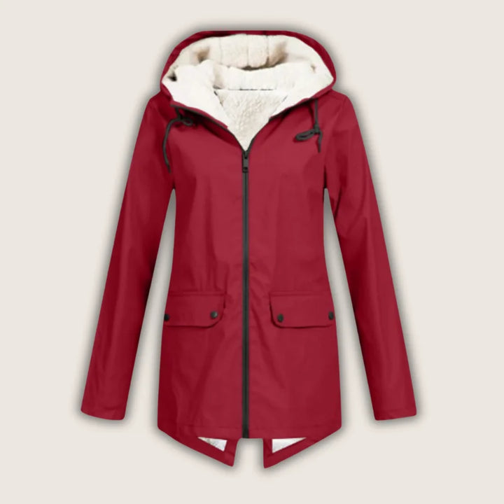 Women's waterproof hooded jacket for rain protection. Stylish and comfortable outdoor outerwear with front pockets.