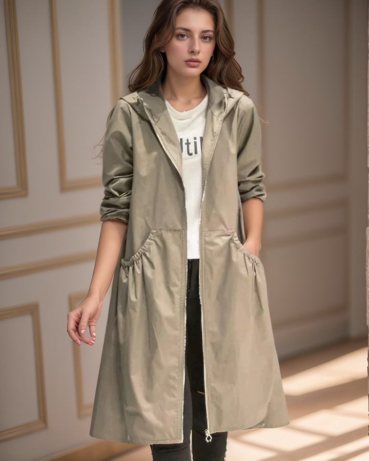 Women's waterproof hooded jacket in knee-length, relaxed fit, shown in lightweight fabric with ruched pockets for stylish cov