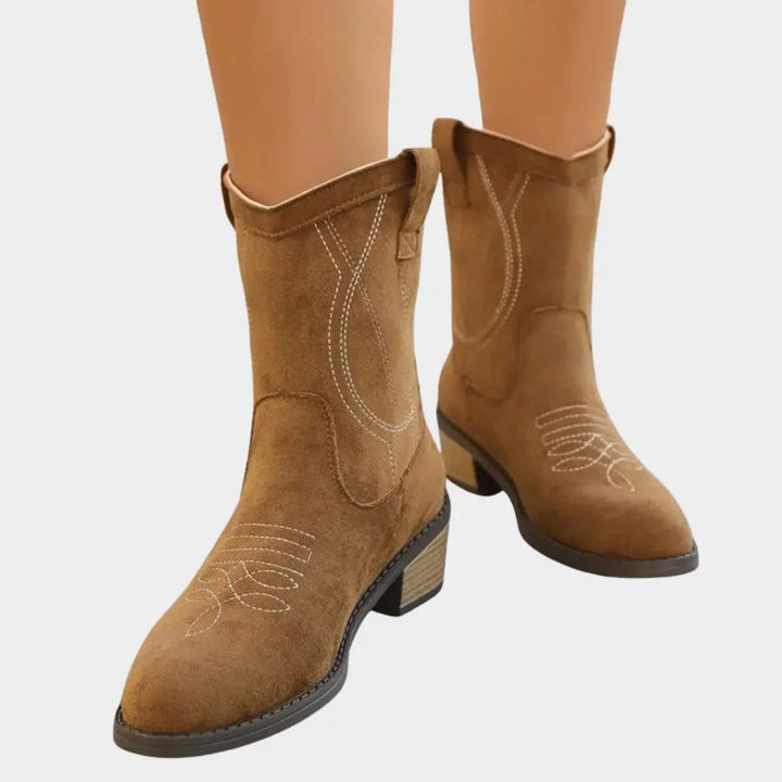 Stylish women's embroidered Western ankle boots, featuring intricate stitching and a comfortable block heel.