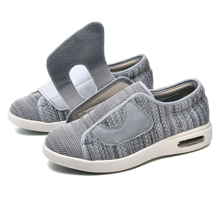 Women's wide fit walking sneakers featuring an adjustable velcro strap and air cushion comfort.