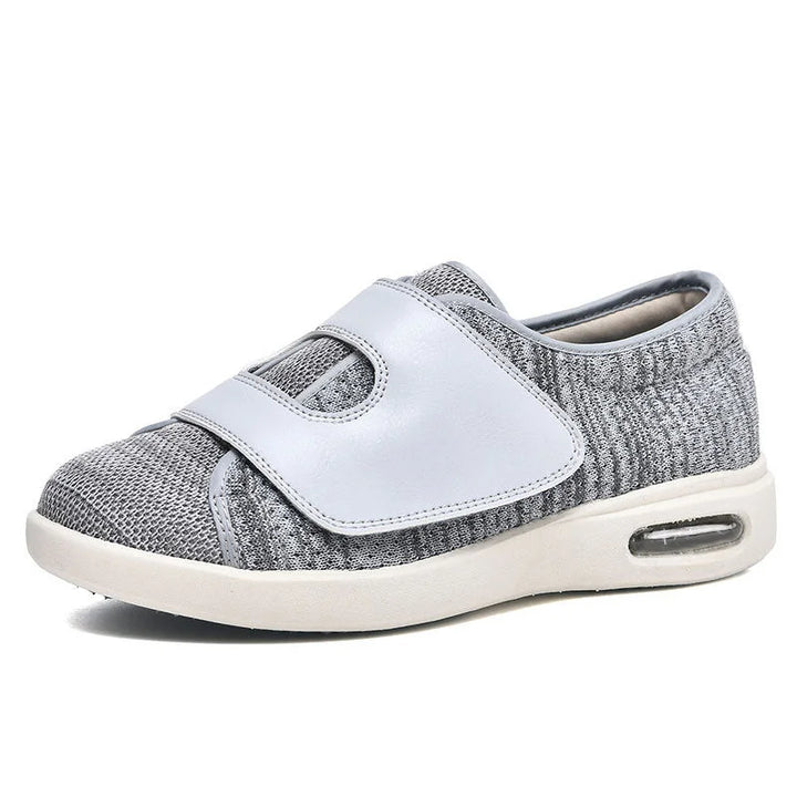 Women's wide fit walking sneakers with adjustable strap, air cushion for comfortable foot support.
