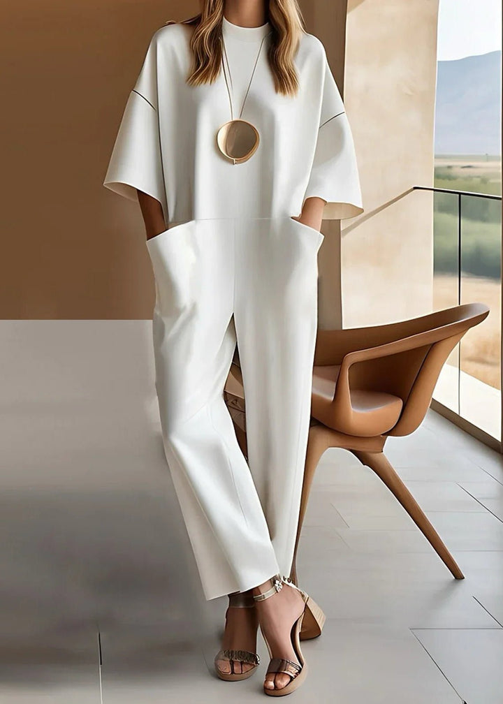 Elegant women's wide leg jumpsuit with short sleeves & crew neck. Perfect for chic, comfortable style.