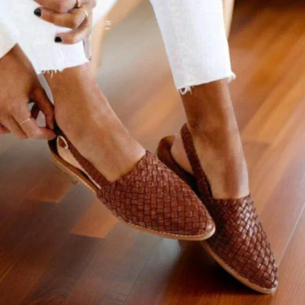 Women's woven leather sandals with slingback, featuring a hand-woven design and cushioned sole for all-day comfort.