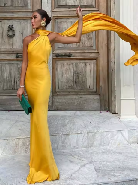 Dramatic women's formal cape maxi dress with flowing train. Elegant one-shoulder gown for special occasions.