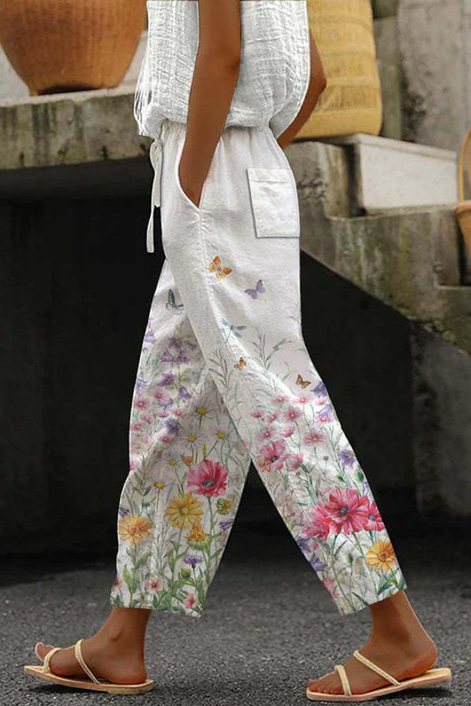 Full-length view of flattering women's casual printed pants, featuring buttons, pockets & a comfortable fit.