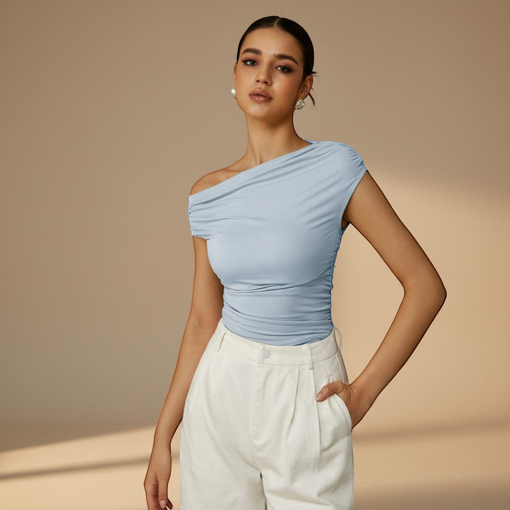 Modern women's top: one-shoulder, ruched, and asymmetrical for a chic, fitted summer style.