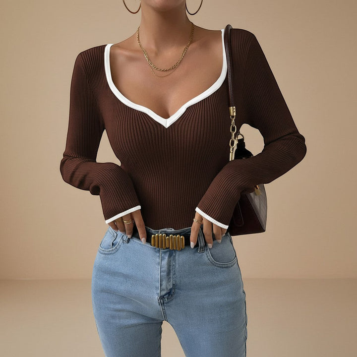 Women's essential ribbed long sleeve V-neck top with a subtle yet distinct contrast trim. Modern look.