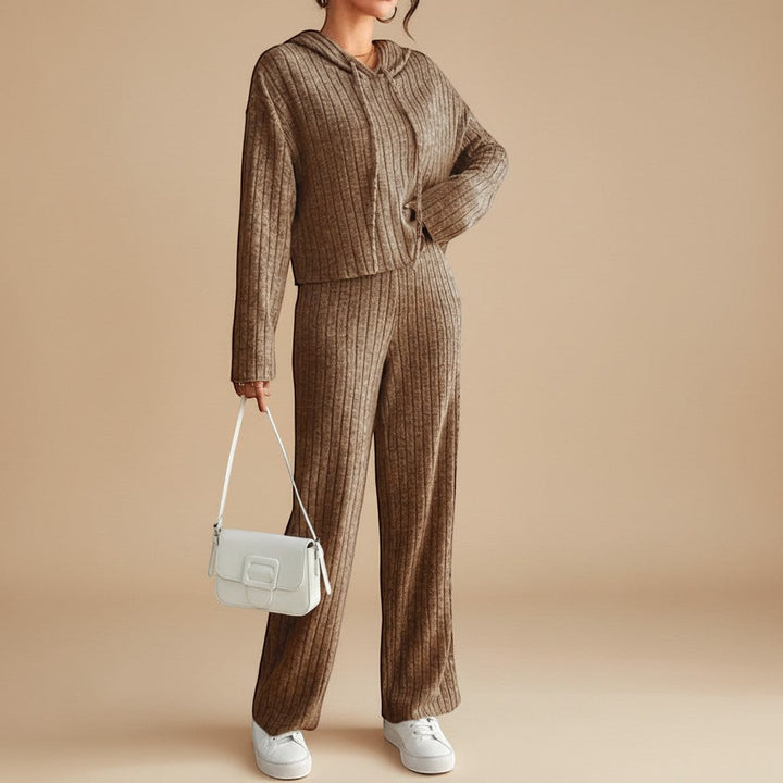 Casual women's two-piece ribbed loungewear set with a relaxed fit hoodie and comfortable straight-leg pants.