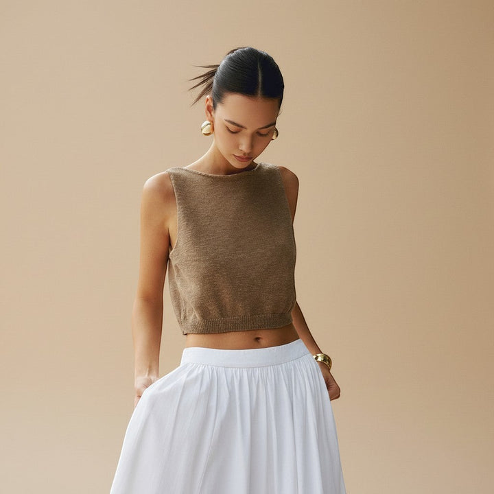 Textured women's sleeveless crop top with a high neckline, ideal for chic summer fashion.