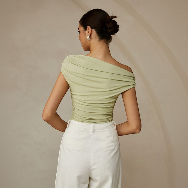Elegant women's sleeveless ruched top, modern asymmetrical one shoulder blouse in a fitted style.
