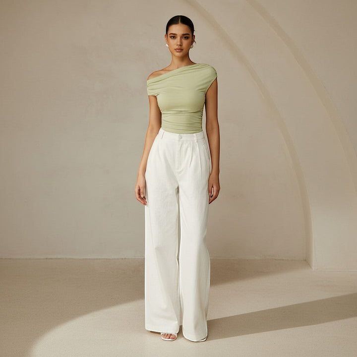 Fitted women's ruched top with a chic one shoulder, asymmetrical design for a modern look.