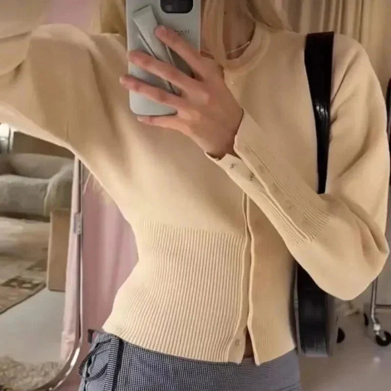 Soft knit women's button-up cardigan with ribbed trim, an elegant and versatile layering top for any season.