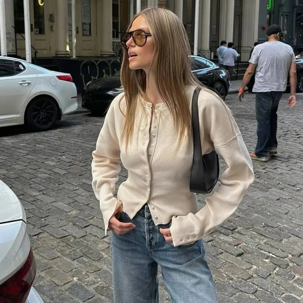 Stylish women's button-up knit cardigan with a classic round neck & ribbed trim, ideal for versatile layering.