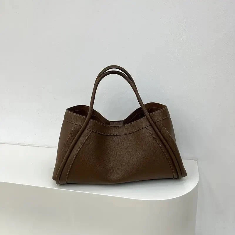 Minimalist women's everyday tote. Structured handbag for daily essentials, versatile carry with a chic, modern design.