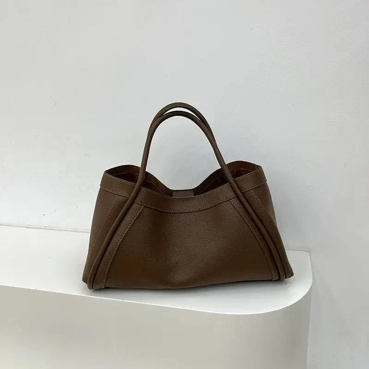Minimalist women's everyday tote. Structured handbag for daily essentials, versatile carry with a chic, modern design.