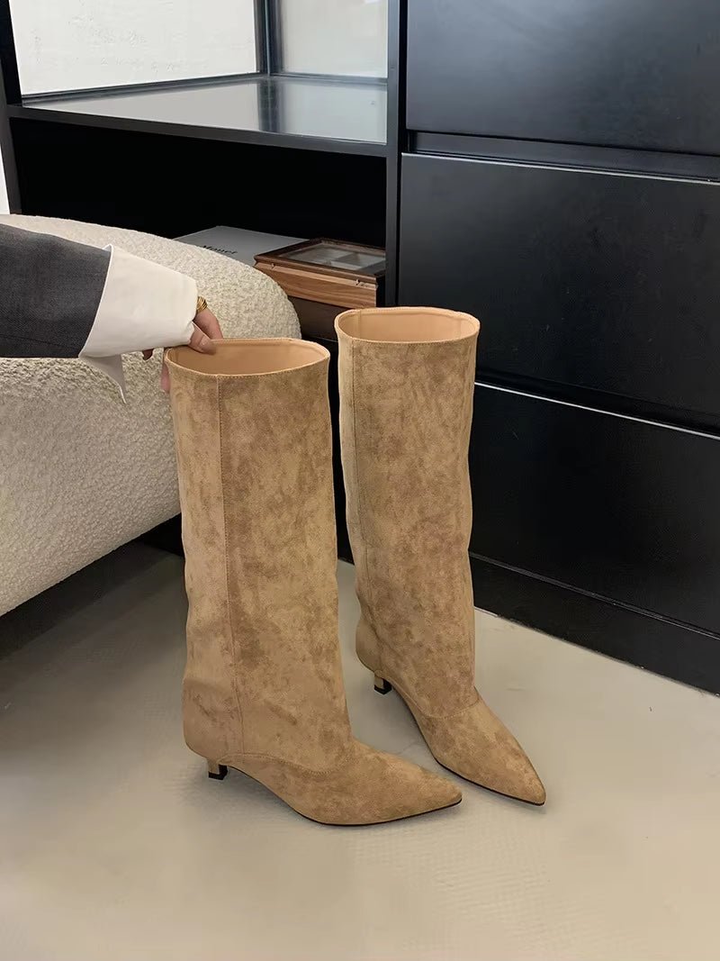 Timeless women's elegant knee-high boots. Features a comfortable kitten heel and pointed toe for versatile style.
