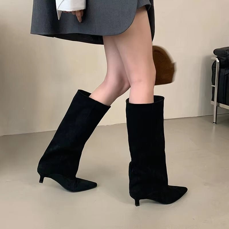 Elegant women's knee-high boots with a chic kitten heel and pointed toe, perfect for fall and winter fashion.