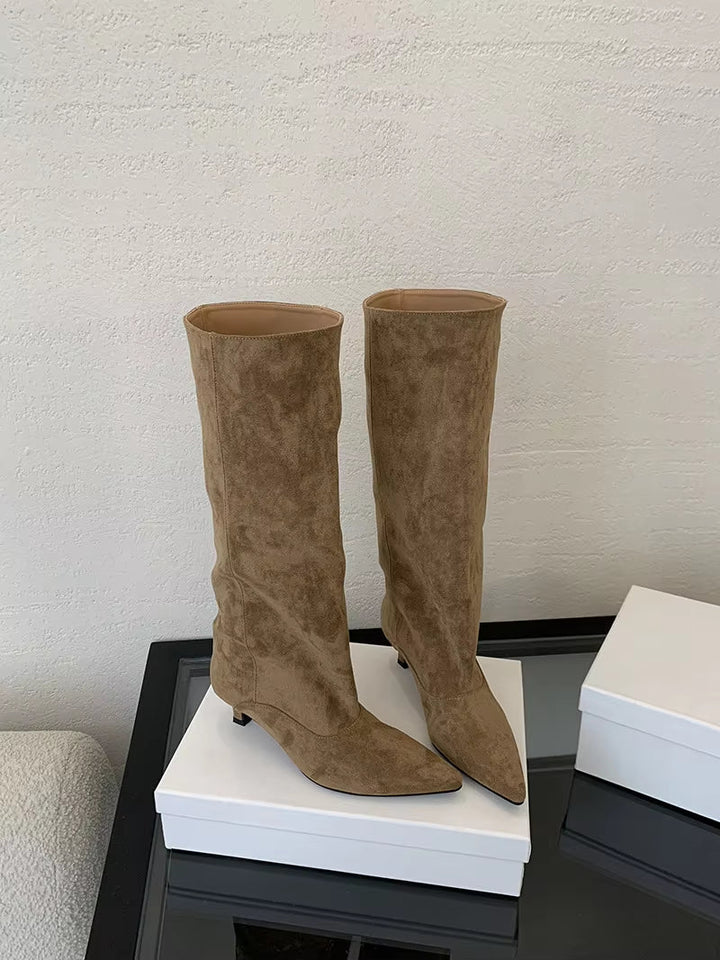 Stylish women's fashion knee-high boots. Offers sophisticated style with a comfortable kitten heel and pointed toe.