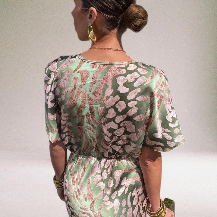 Beautiful women's elegant maxi dress. V-neck, cinched waist, flowing fabric. Ideal formal evening or wedding guest attire.